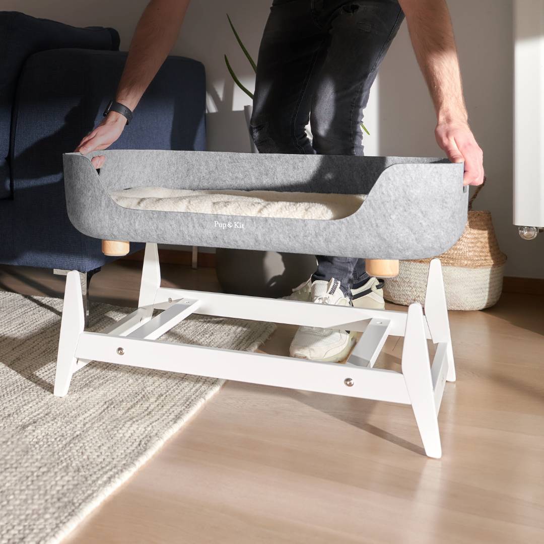 Pup & Kit PetNest being lifted off a wooden raised dog bed